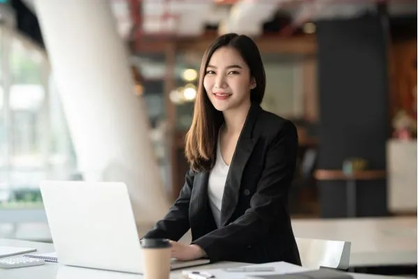 Permanent recruitment specialists using laptop to source and screen CV